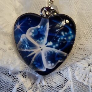 Blue butterfly heart necklace.